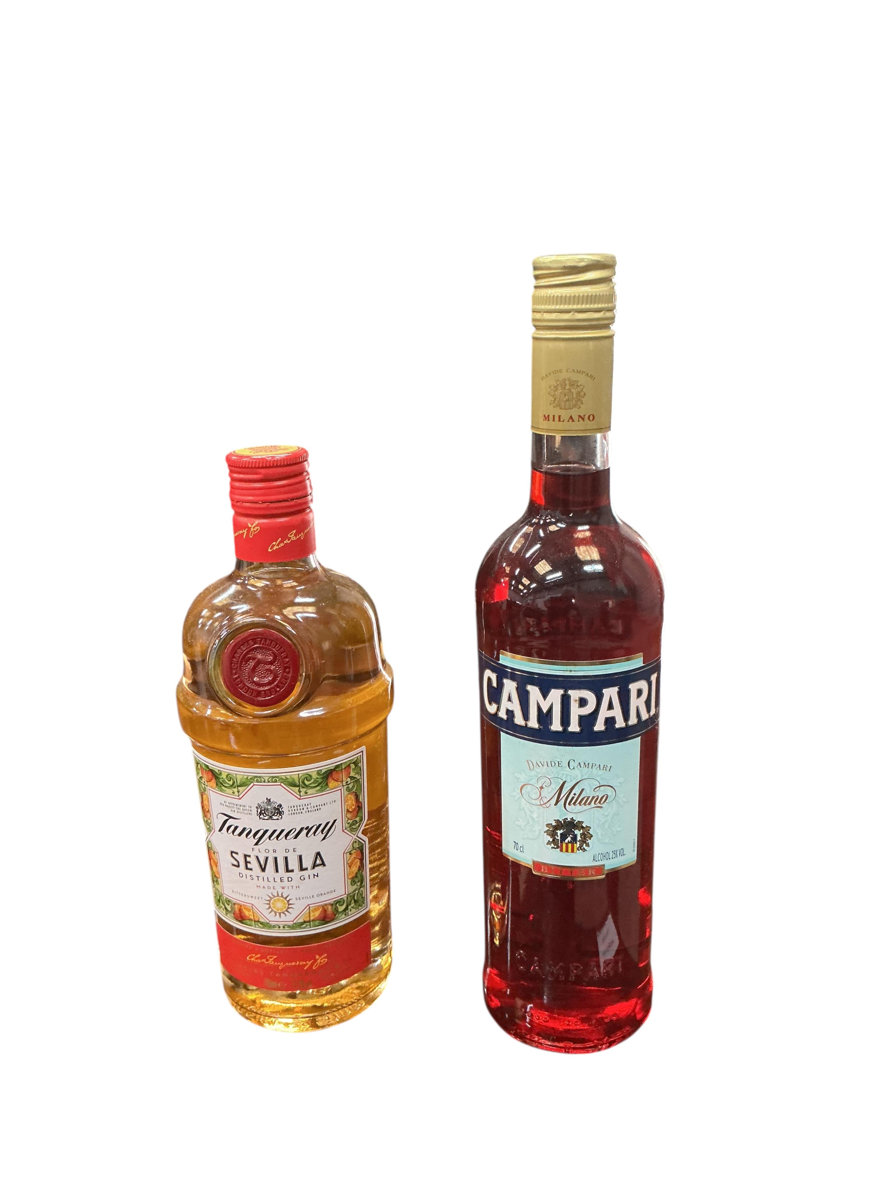 Four bottles of British artisan gin, a bottle of Tanqueray Sevilla and Bombay Sapphire gin and a bottle of Campari. (Provenance, surplus stock from a local wedding company)